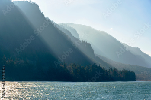 Mountain range illuminated by the slanting rays of the sun on the banks of the Columbia River in Colombia Gorge photo