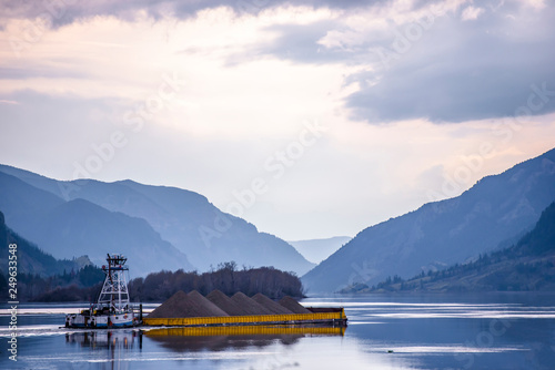 Small powerful tug like an ant pushing loaded barge on the Columbia River © vit