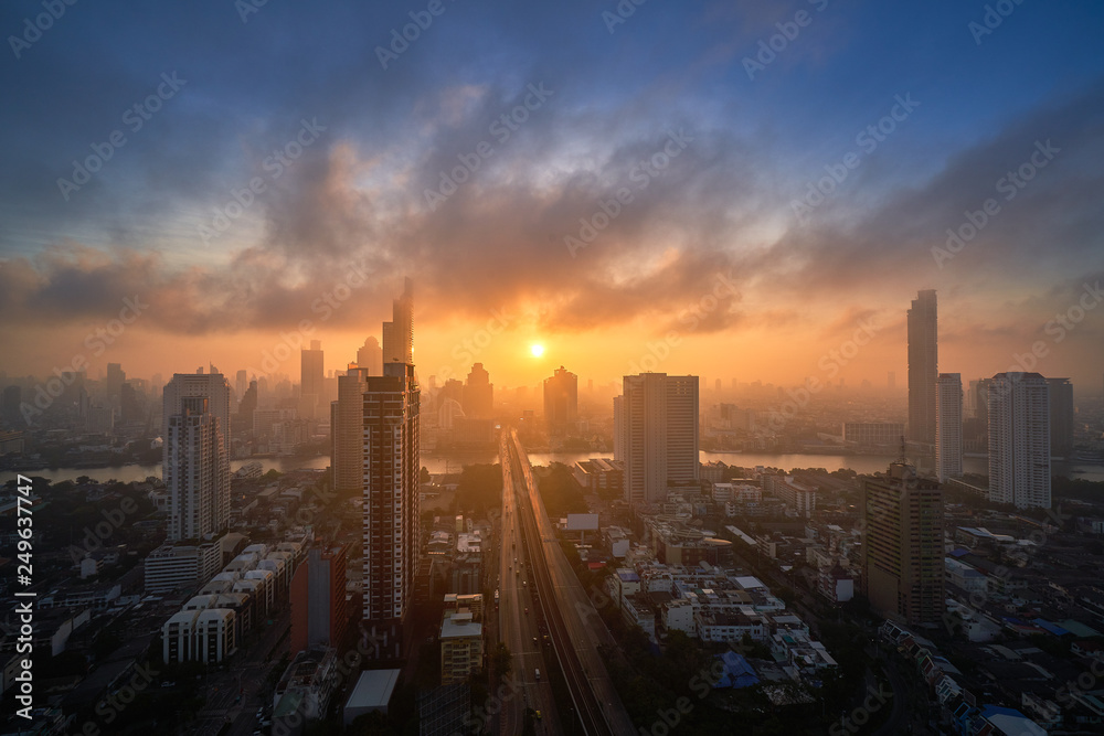 sunrise skyline with cityscape and bridge cross the river