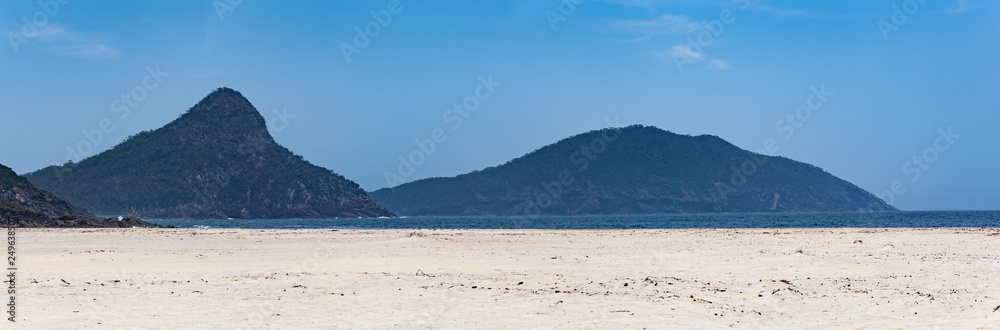 Wide panorama of forested hills and sandy beach at Fingal Bay, New South Wales, Australia