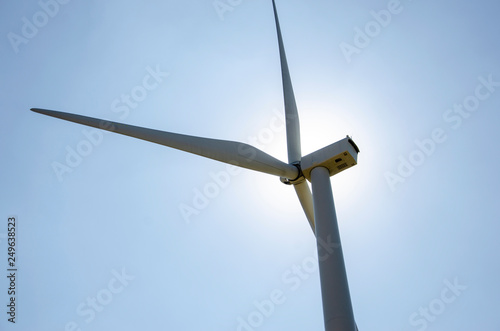 Wind turbines generate electricity as alternative energy to the sky background. © Kunchit