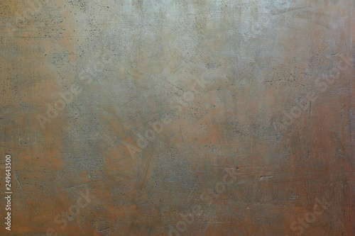 Grey brown painted scratched grunge plaster wall as abstract textured background.
