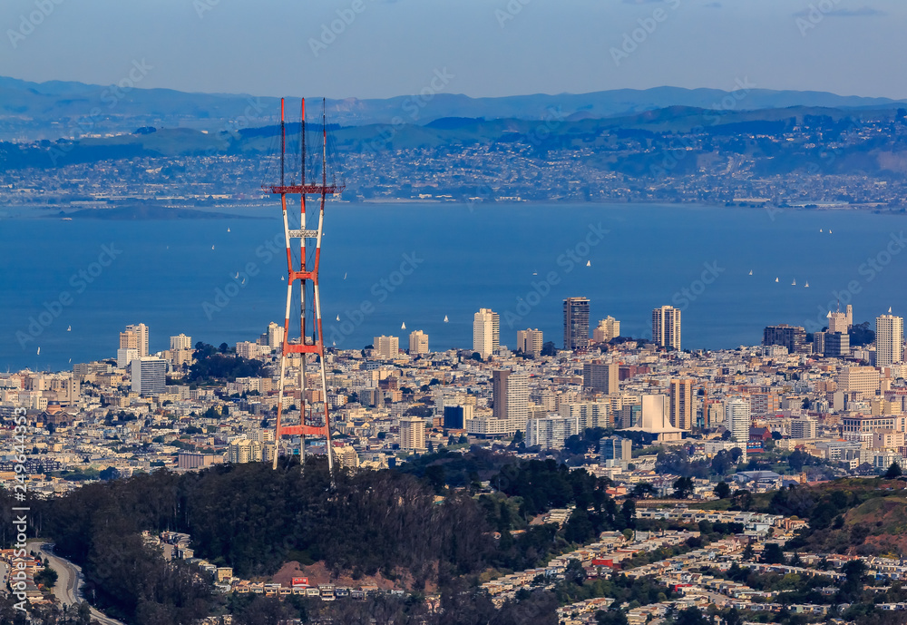 Aerial view of San Francisco skyline with Sutro tower in the foreground, flying over Twin Peaks