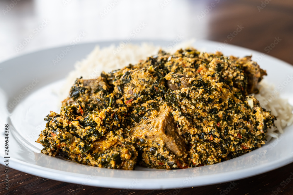 Nigerian Egusi Melon soup served with white rice at restaurant Nigerian Egusi Melon soup served with white rice at restaurant