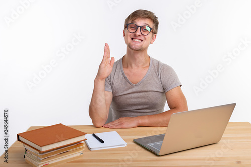 Study, education and emotions concept - male student doing exercises in laptop, looking amazed