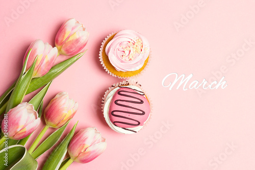 Cupcakes in shape of number 8 with tulip flowers on pink pastel background. March 8.