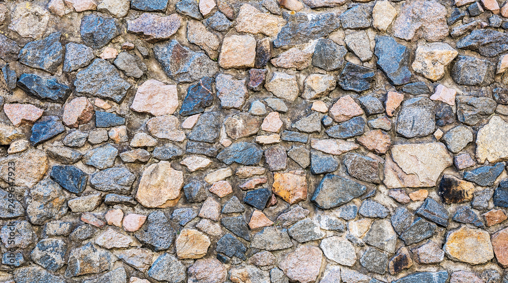 Texture of old rock wall for background. A castle wall of multicolored stones or blocks. Stacked stone wall Texture of old rock wall for background. A castle wall of multicolored stones or blocks. Stacked stone wall