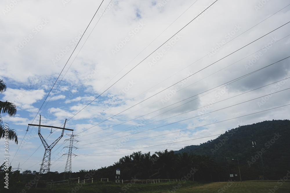 View transmission towers (power tower, electricity pylon, steel lattice tower) cloud blue sky. Texture high voltage pillar, overhead power line, industrial background. - Image