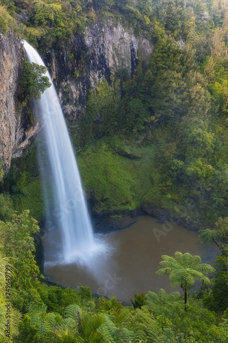 Rain forest to the North Island  New Zealand. Concept of active and ecological tourism. Bridal veil Fall on a foggy morning Bridal Veil Falls in summer season.