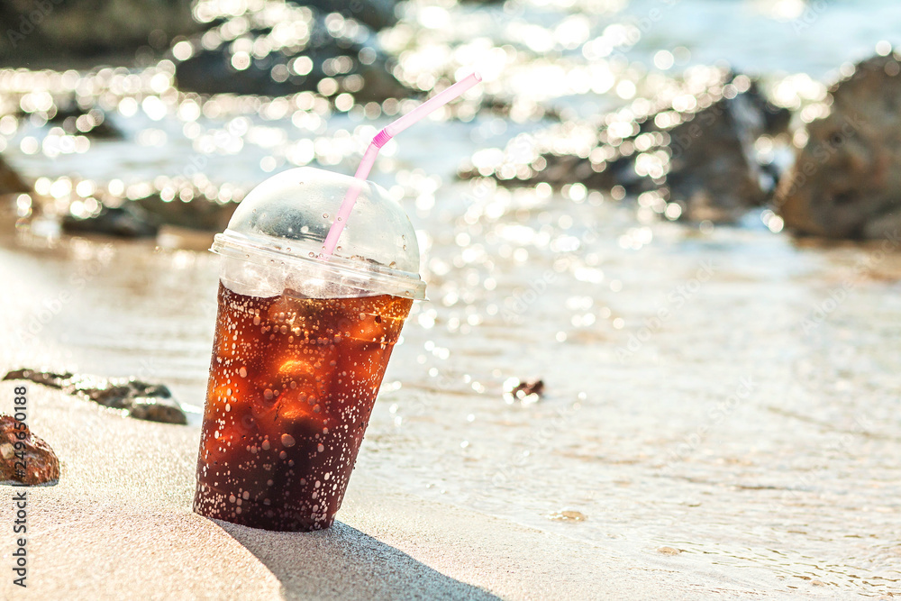 Soft soda Drink with ice in plastic glass at beach Soft soda Drink with ice in plastic glass at beach