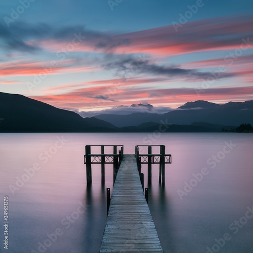 Romantic wharf on Te Anau on South Island of New Zealand Beautiful pier on sunrise. Lake Te Anau is the largest lake in the South Island and within New Zealand second only to Lake Taupo.