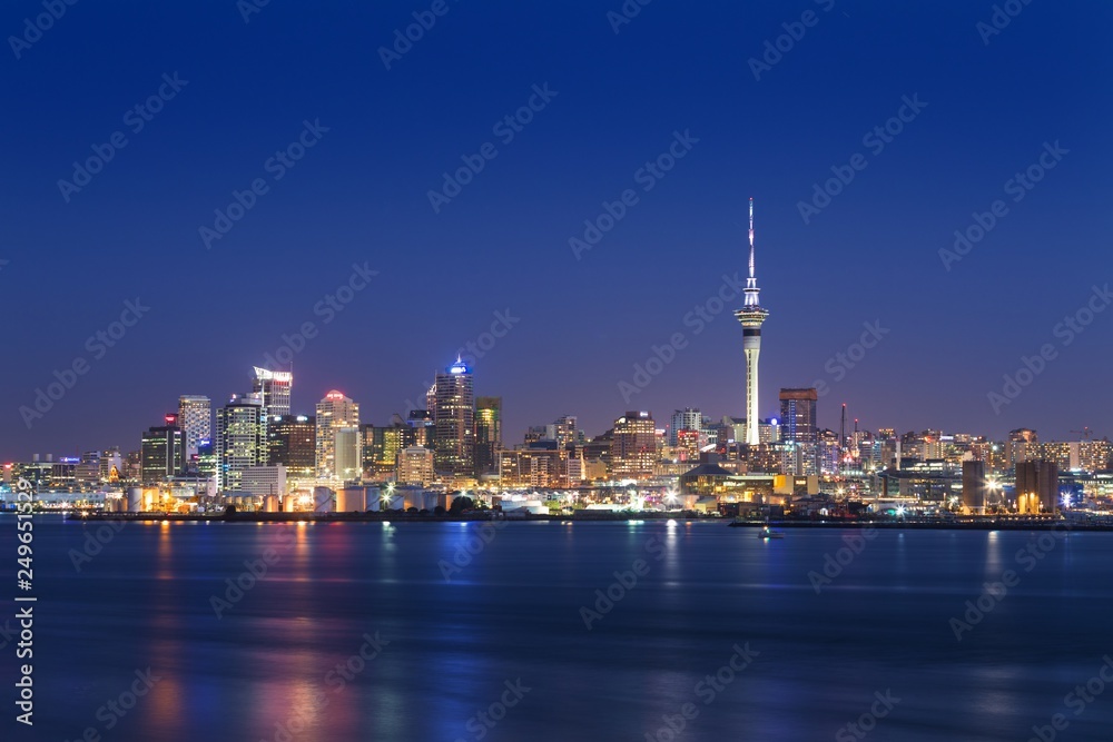 Skyline photo of the biggest city in the New Zealand, Auckland. Photo was taken after sunset across the bay. Auckland City and Sky Tower at Night. Most popular view