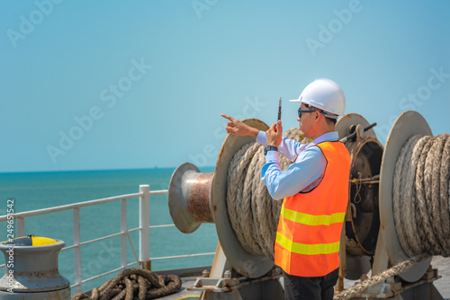 Konstfotografi ship crew under safe working in communicating for mooring wince on board the shi