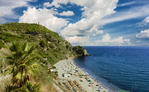 The Playa De Maro (Maro Beach) with a big sky with clouds. Tourist resort in Costa del Sol, Andalusia, Spain. photo