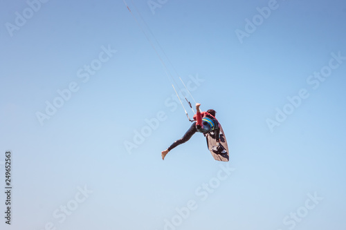 Kite surfer performing difficult tricks in high winds. Extrme sports shot in Tarifa, Andalusia, Spain