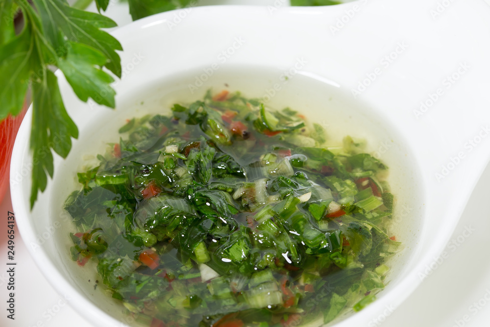 Bowl with chimichurri sauce for steak. Bowl with chimichurri sauce for steak.