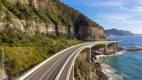 Travelling on the sea cliff bridge coastal drivel along the pacific ocean. Grand pacific drive, East coast of Australia. Clear sunny day.