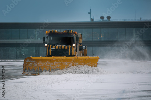 Canvastavla Snowplow removing snow from runways and roads in airport during snow storm