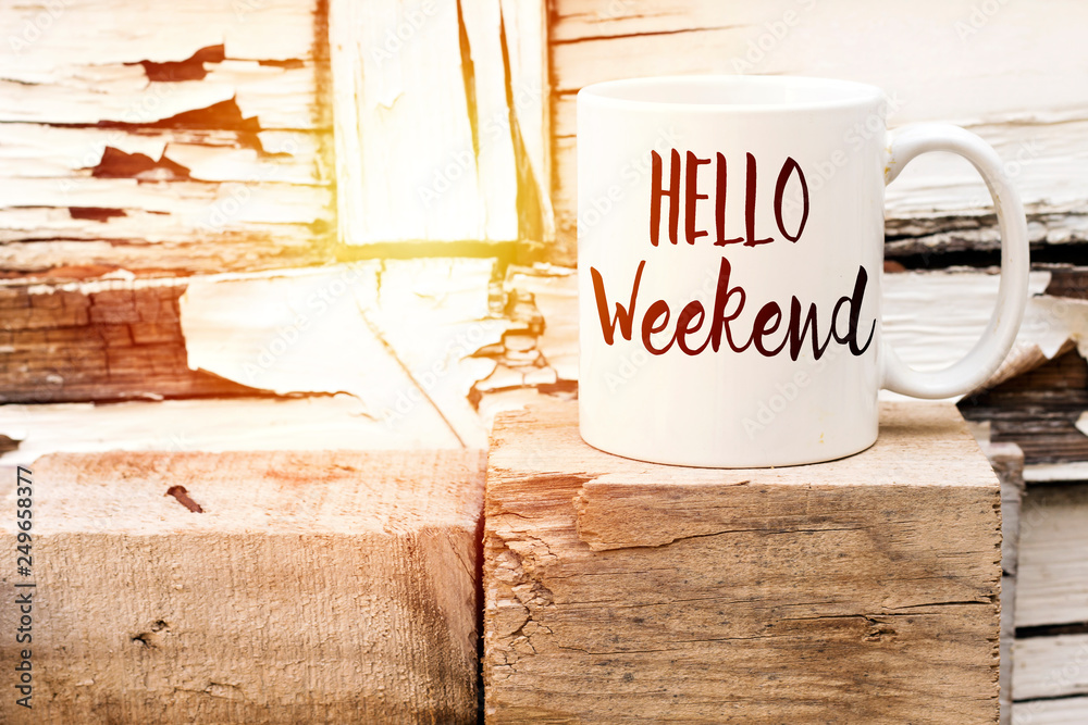 text HELLO weekend on cup of aromatic coffee on wooden cube Stock Photo ...