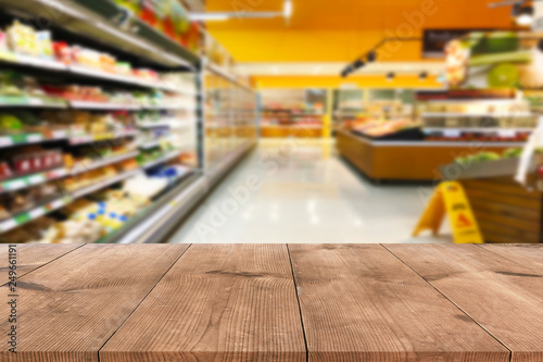 Empty wood table top on shelf in supermarket blurred background