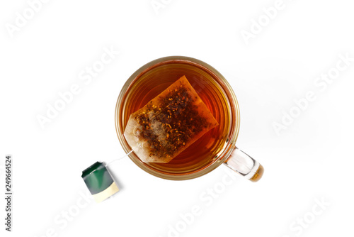 Glass cup of black tea with tea bag. Close up. Top view. Isolated on white background