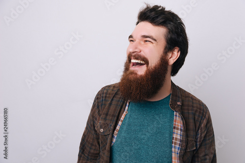 Fotografie Headshot of satisfied cheerful handsome bearded man, glad to find suitable well