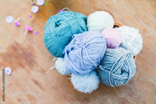 Women's hobby. Knitting and knitting needdles on the wood table in the garden on a Sunny summer day.	 photo