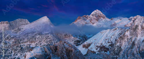 First snow and magnificent sunset in the mountains. Photo of amazing scene in European Alps. View to highest peak of Slovenia. Triglav National Park, Julian Alps Beautiful winter landscape with snow photo