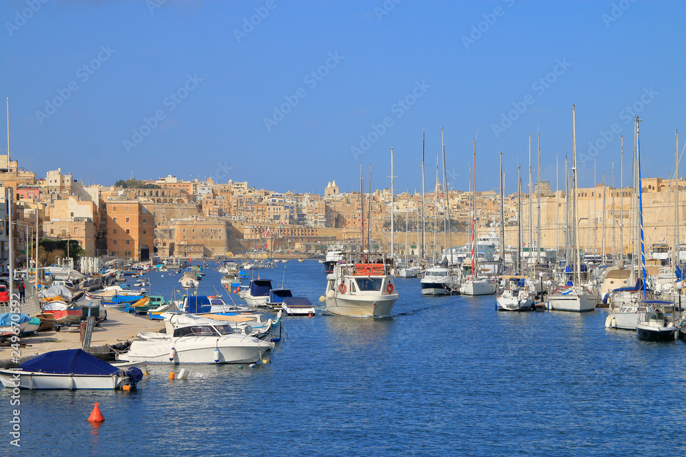 Boat trip on the harbor of the island of Malta along moored yachts.