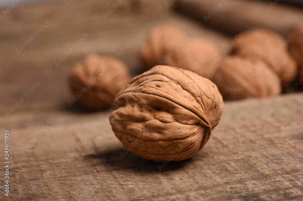 Walnut kernels and whole walnuts on rustic old oak table. Walnut kernels and whole walnuts on rustic old oak table.