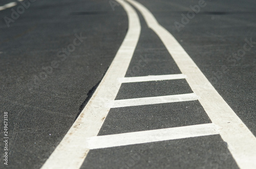 Double solid strip on the road. Two white stripes on the asphalt. Separation bars on the track. The prospect of a close-up road. Road marking.