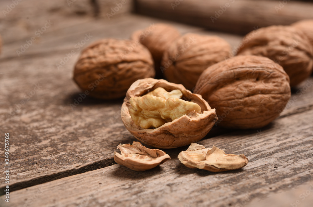 Walnut kernels and whole walnuts on rustic old oak table. Walnut kernels and whole walnuts on rustic old oak table.