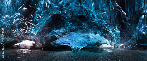 Foto Blue crystal ice cave and an underground river beneath the glacier