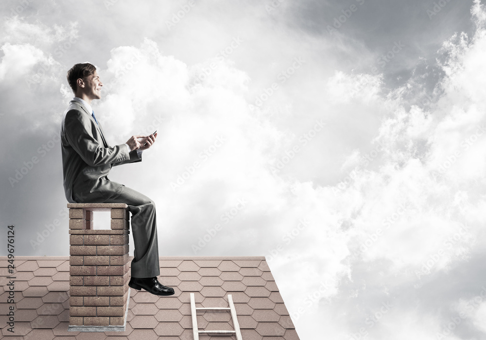 Businessman or student on brick roof smiling and making calls Businessman or student on brick roof smiling and making calls