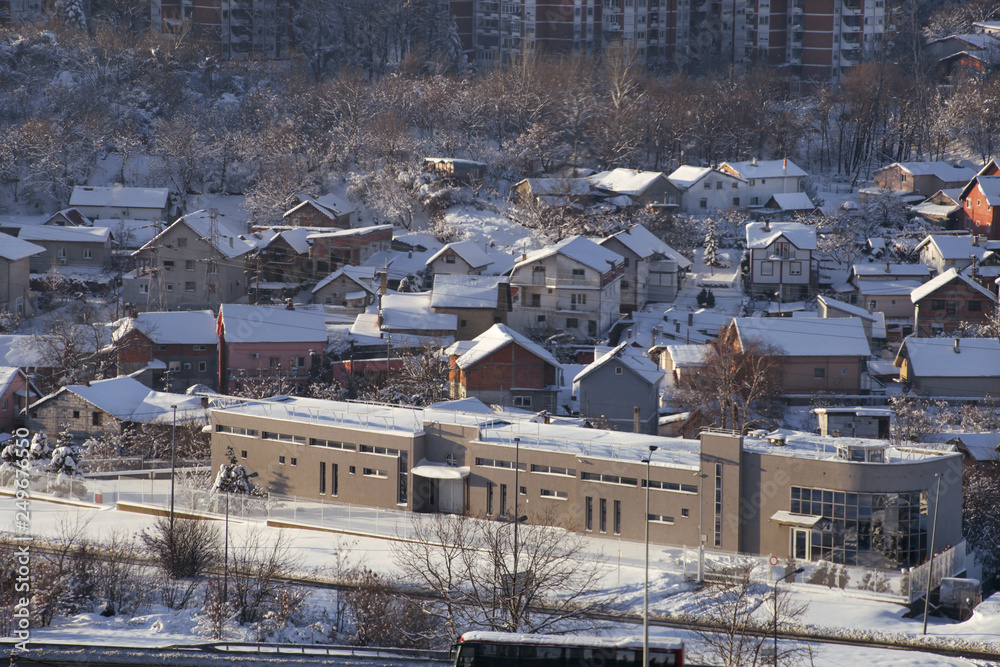 Beautiful winter view of houses and buildings with roofs covered with heavy snow. In snowy season, roof with lot snow because of snow drifting, big snow layer. Winter day, weather, seasons specific.