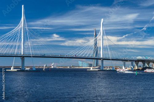 A new white cable-stayed bridge across the Neva River. Large cable-stayed bridge against the blue sea. Modern bridge construction. The central part of the WHSD. Russia. St. Petersburg © Artem