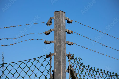 Barbed wired fence providing security to farmland in rural Hampshire