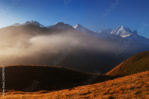 A panoramic view on Chamonix valley from in summer sunny day. The area is the stage of the popular Mont Blanc Tour, France. Beautiful holidays day in Alpes. Amazing background landscape concept.