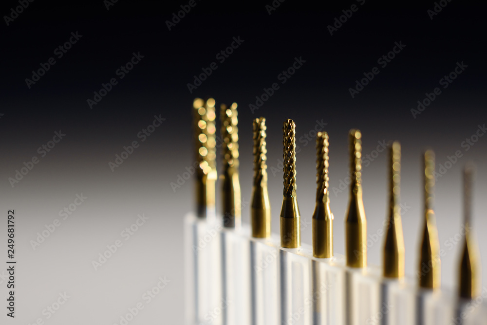 Metal cutting machine tool, shallow depth of field, cutters close-up, drill bit on the table