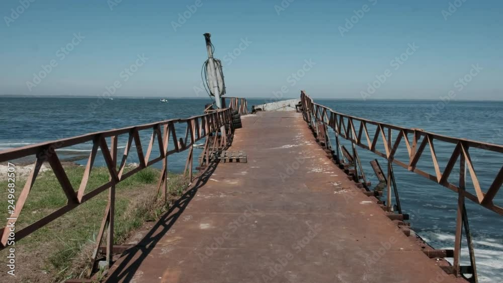 Walk on the old rusty bridge on the sea