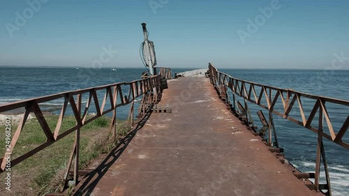 Walk on the old rusty bridge on the sea