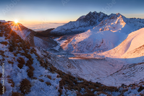 Mountains panorama from the High Tatras, Slovakia Beautiful winter mountain landscape with colorful clouds after sunrise. Wonderful Carpathian mountains background concept. Amazing structures in snow.