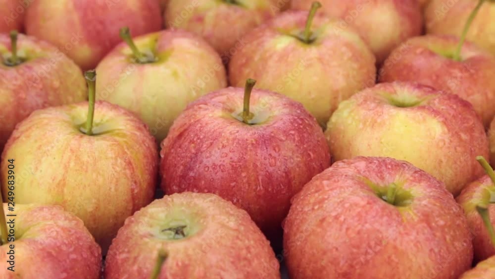 Raindrops falling on rotating apples. Close-up. Raindrops falling on rotating apples. Close-up.