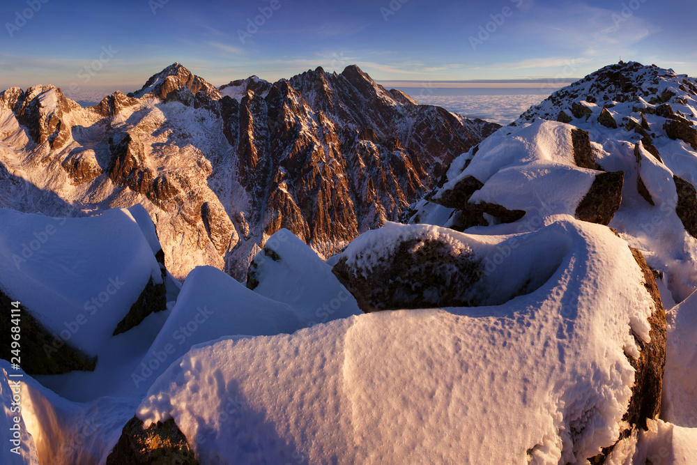 Mountains panorama from the High Tatras, Slovakia Beautiful winter mountain landscape with colorful clouds after sunrise. Wonderful Carpathian mountains background concept. Amazing structures in snow.