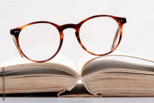 Eyeglasses on open book close-up
