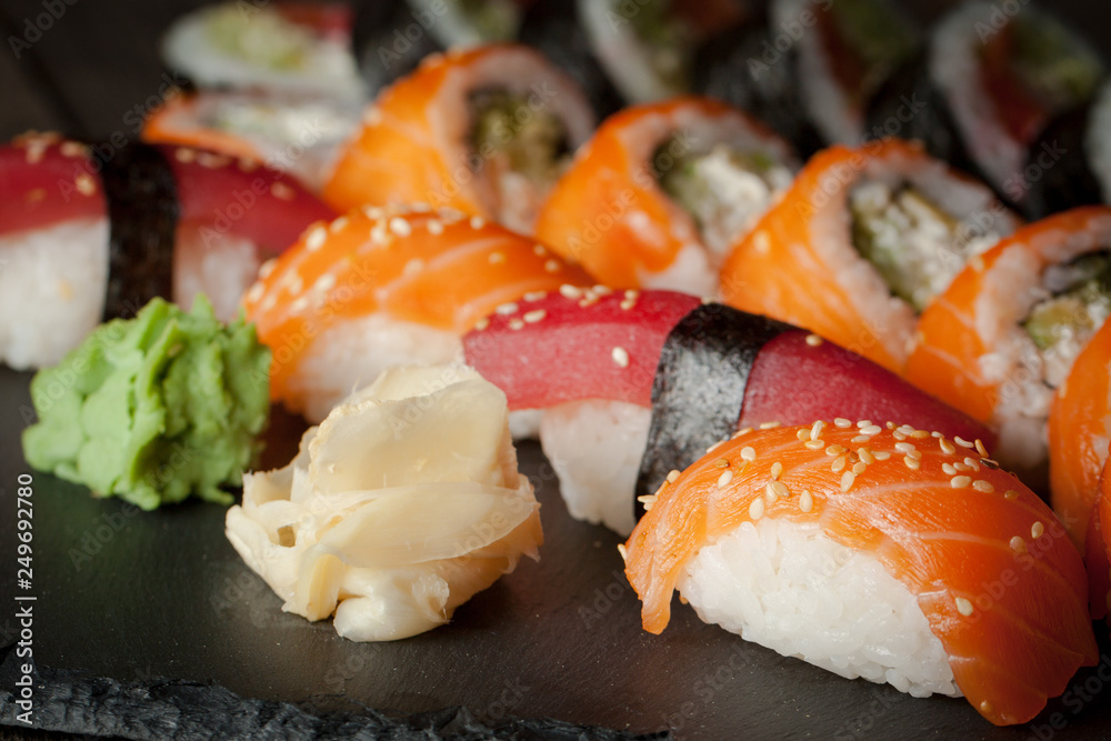 Maki rolls and nigiri sushi on a wooden table. Salmon, avocado and caviar rolls. Maki rolls and nigiri sushi on a wooden table. Salmon, avocado and caviar rolls.