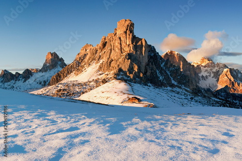 Fantastic winter landscape, Passo di Giau (Giau Pass) with famous Ra Gusela, Nuvolau peaks in background, Dolomites, Italy Italy with blue skies and clouds in the background taken on a sunny day. 