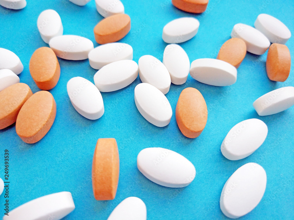 Pharmaceutical pills, tablets and capsules on blue background. Medicine concept, pharmacy, treatment and drugs prescription theme Pharmaceutical pills, tablets and capsules on blue background. Medicine concept, pharmacy, treatment and drugs prescription theme