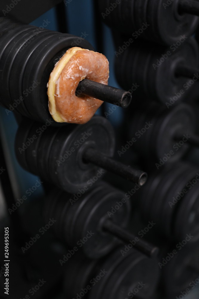 a donut is on a weight rack, a metaphor for a tough life choice a donut is on a weight rack, a metaphor for a tough life choice