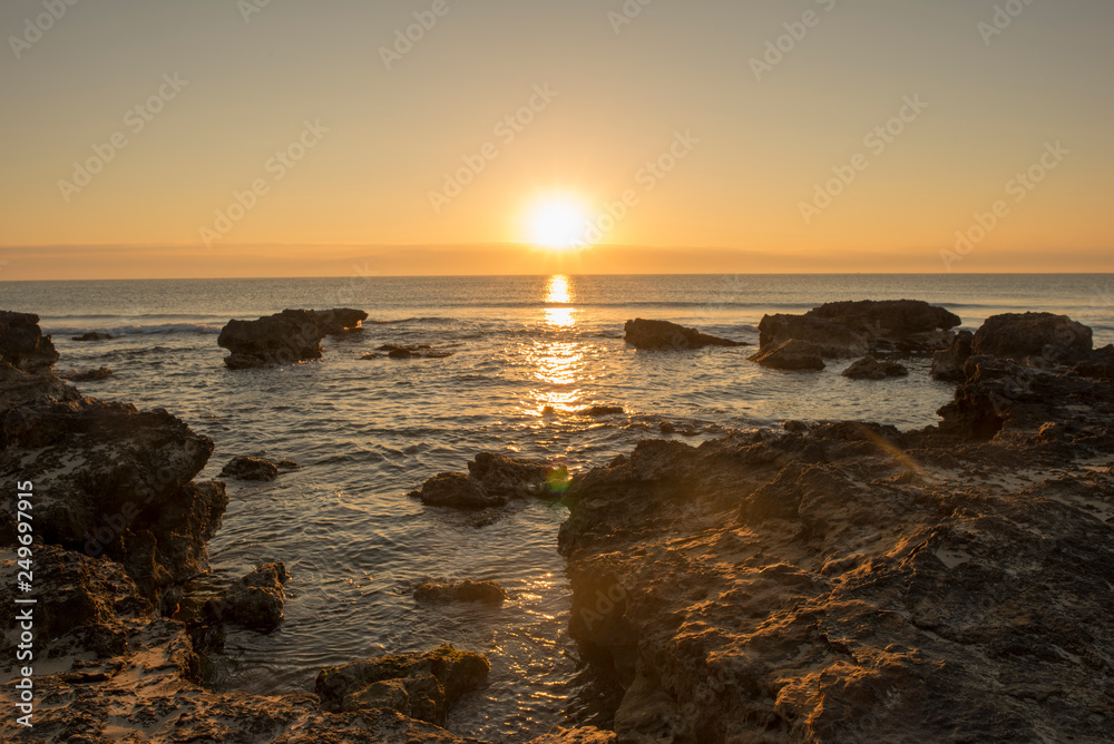 A sunrise between the rocks of Oropesa del Mar